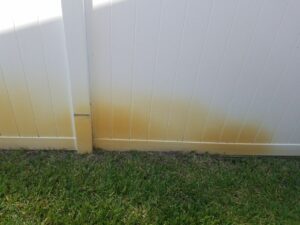 white fence with red rust stain