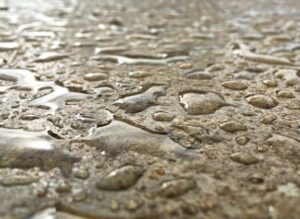 close up image of sealed concrete repelling water